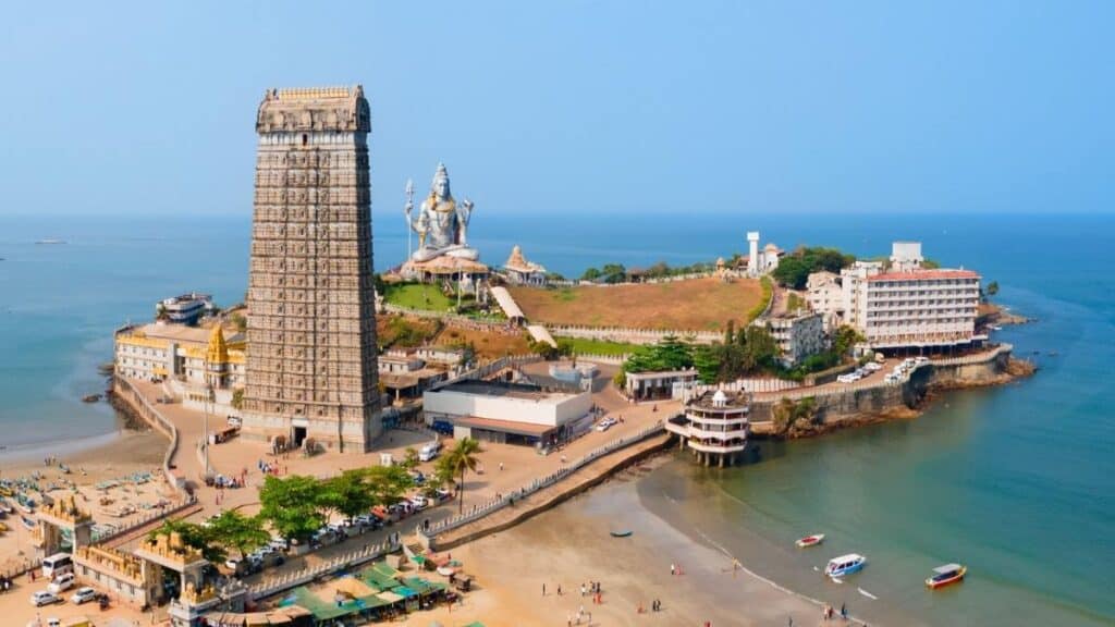A majestic aerial view of the 123-foot Shiva statue and the 20-storey Raja Gopura at Murudeshwar, Karnataka.