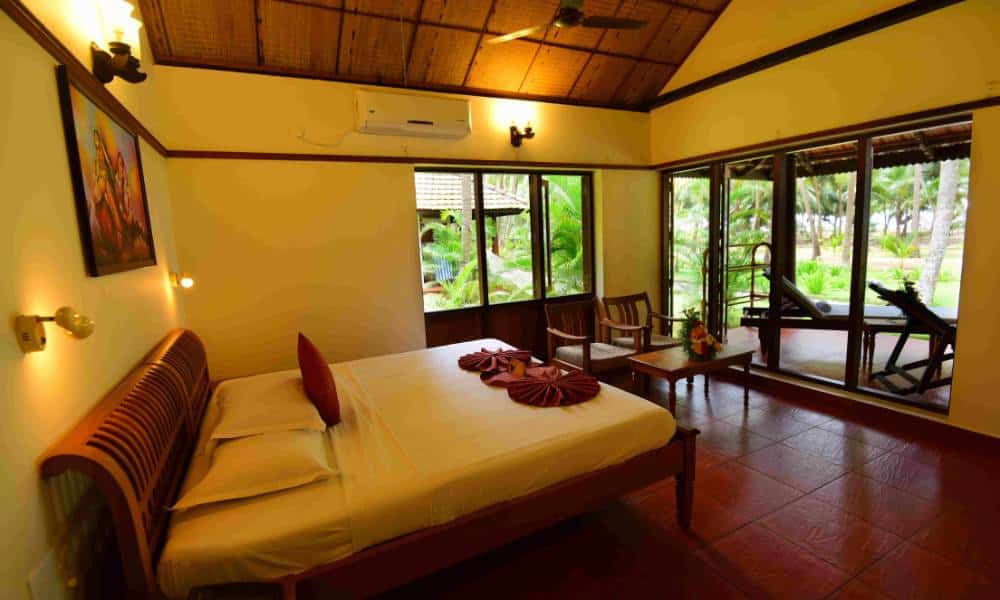 Lush coconut groves and luxury villas at Nattika Beach Ayurveda Resort in Thrissur, Kerala. Interiors.