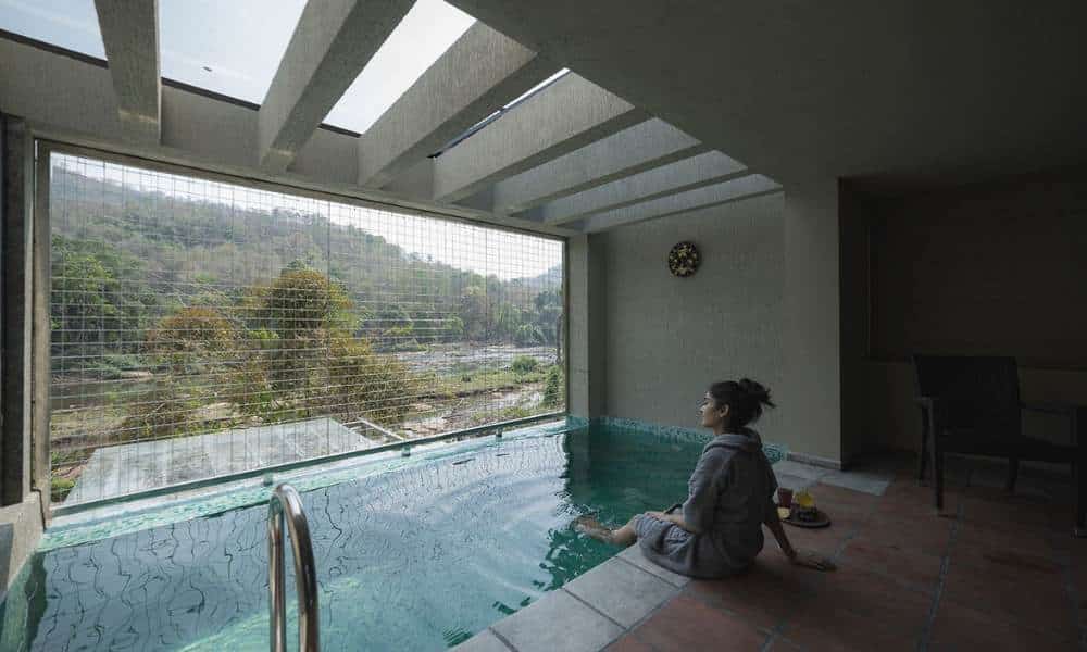Infinity pool overlooking the Athirappilly waterfalls at Niraamaya Samroha.