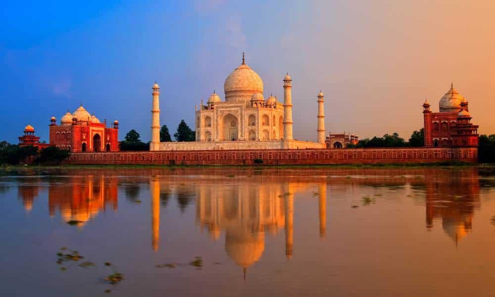 The Taj Mahal framed by the Yamuna River during sunset as seen from Mehtab Bagh gardens.